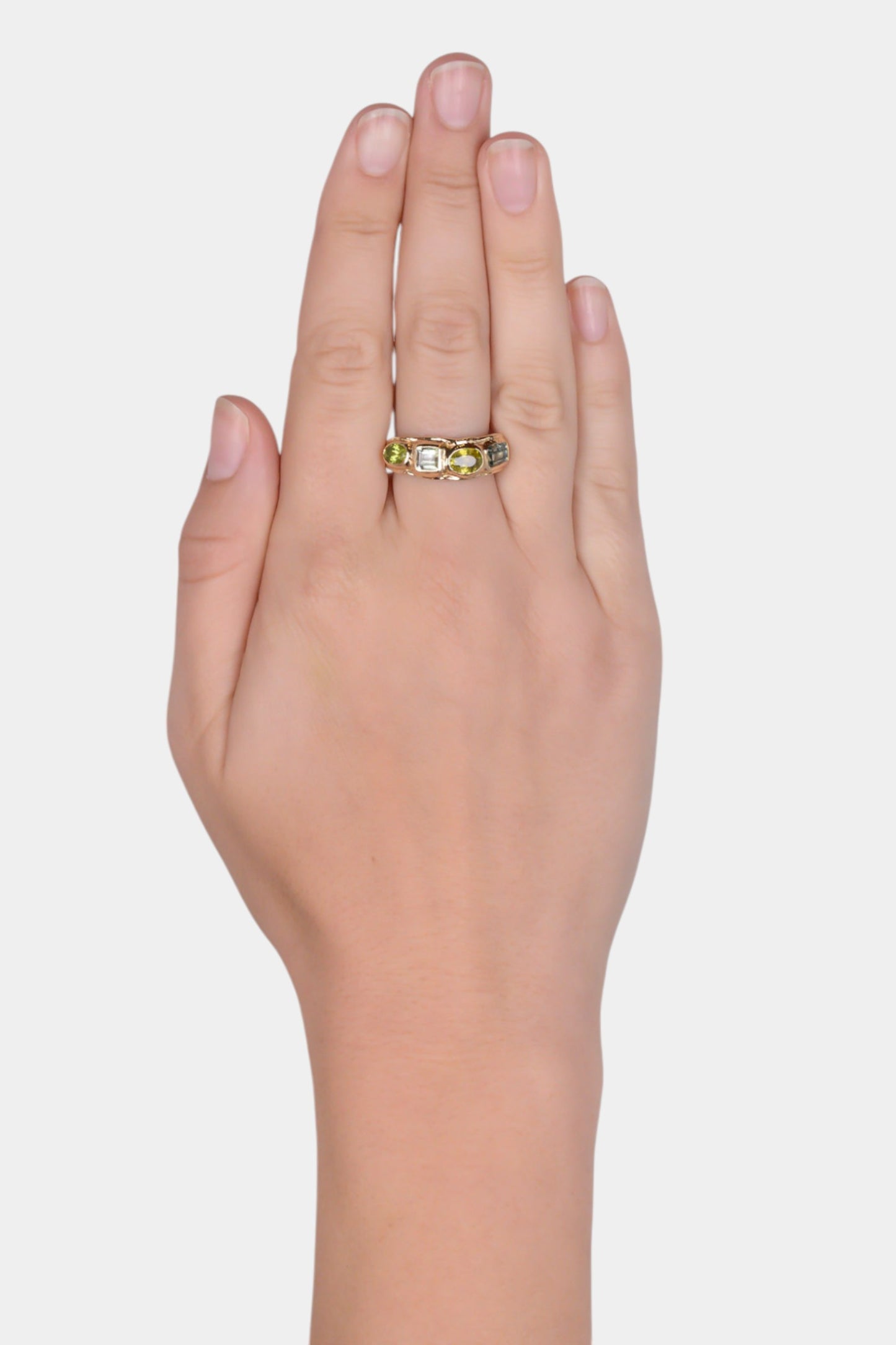 Boogie Wonderland Ring wearing on hand
solid 9 karat yellow gold with all natural stones: emerald cut mint green tourmaline, oval cut sphene, square cut mint green tourmaline, oval cut peridot